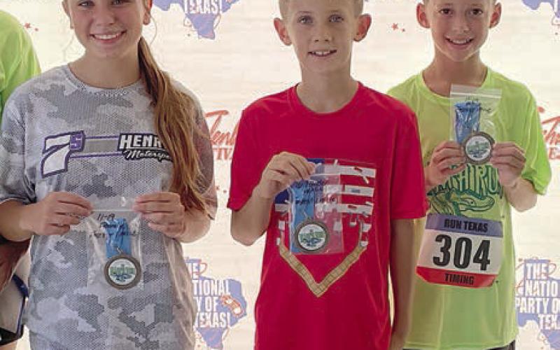 One-mile winners – (from left) Ellie Hammack, 11-19 female; Tripp Brown, 10 &amp;amp; under male; and Levy Herrera, 11-19 make. Not shown: Judy Falke, 20 &amp;amp; over female. Sticker Photo By Darrell Vyvjala