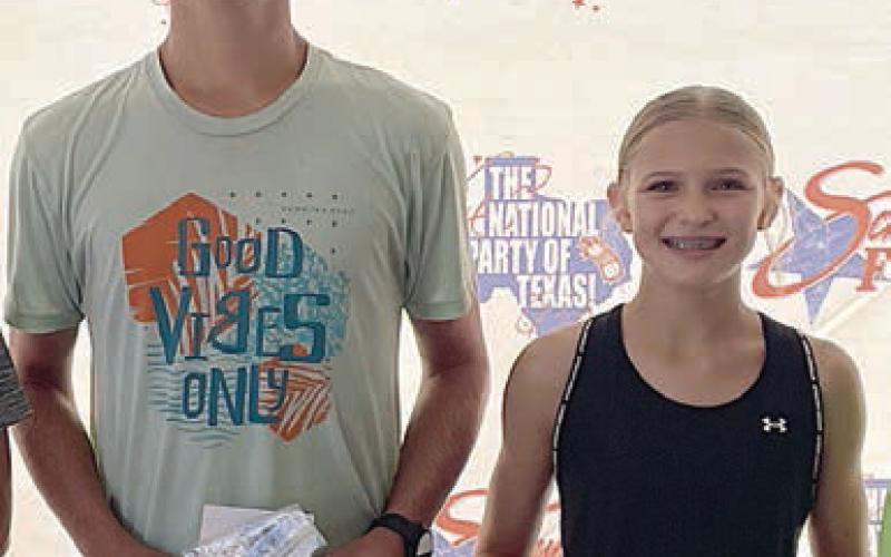 Overall 5K winners – (from left) Ty Lewis and Avery Lewis. Sticker Photo By Darrell Vyvjala