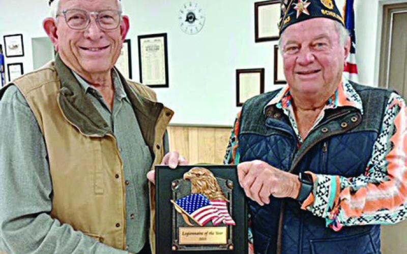 Post Commander Bob Heinrich (right) presents the Legionnaire of the Year award to Harvey Oeding.