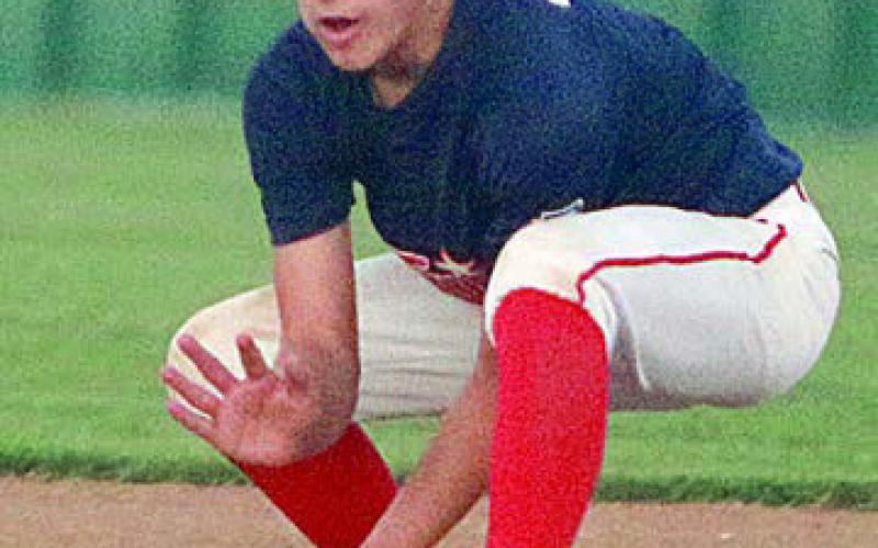 Shortstop Cal Schiffli (left) and second baseman Dylan Zweschper (right) scoop up ground balls for outs during Twin Cities’ District 13 championship game victory last Friday night at the Sports Complex. Sticker Photos By Darrell Vyvjala