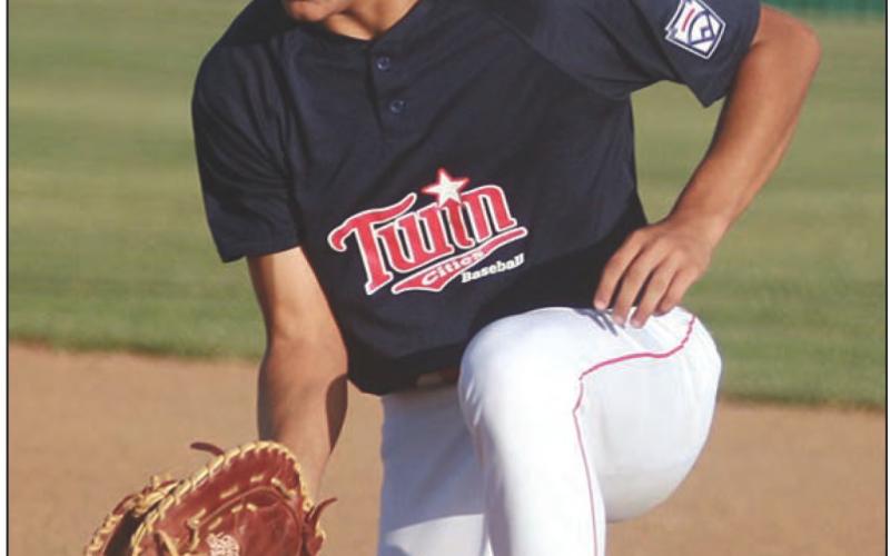 First baseman Julian Saucedo snags a hard-hit grounder in the top of the second inning. Sticker Photo By Darrell Vyvjala