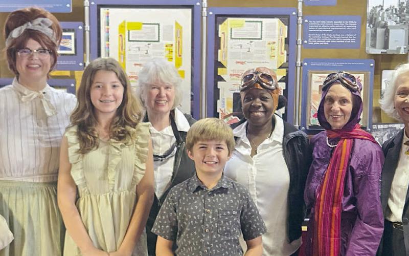 Performing in “Wings of Their Own: Influential Women in Aviation” were (front row, from left) Remi Denham, Tucker Denham, (back row) Kristen Graeter Holub portraying Dorothy Schmidt, Elota Patton portraying Evelyn “Bobbi” Trout, Rebecca Powe portraying Bessie Coleman, Jaci Elliott portraying Harriet Quimby and Janis Richardson portraying Sophie Mühlstein.