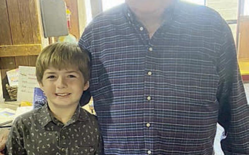YOUTH PERFORMER Tucker Denham (left) poses with Dennis Muhlstein (right).