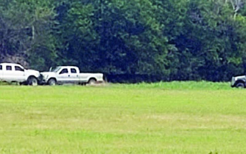 Members of the Austin County Regional Special Response Team approach the stolen vehicle and trailer. Photo Courtesy of the Fayette County Sheriff’s Department
