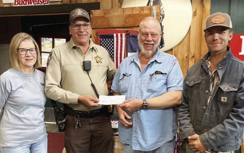For “Make a Difference Day,” Hermann Sons Schulenburg Lodge 14 presented a monetary gift to the Fayette County Deputy Santa program. Shown are (from left) lodge vice president Mary K. Seifert, Deputy Terry Guentert, lodge president Ed Moeller and member Joshua Roberts.