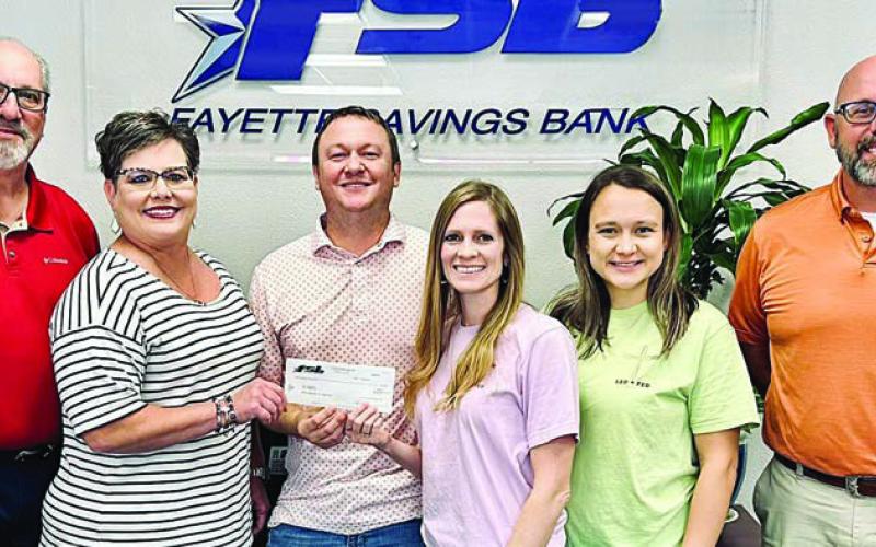 Fayette Savings Bank and Led + Fed representatives on hand for the donation presentation were (from left) Mike Olle and Cheryl Brossmann, FSB; Nathan and Jenny Neiser, Led + Fed founders; Alycia Konvicka, Led + Fed board member; and Brad Tumis, FSB.