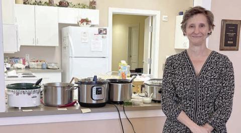 Guest sp eak er was Dawn Orsak, who is authoring a book of Texas Czech foods. She stands in front of pots of soups served at the social.