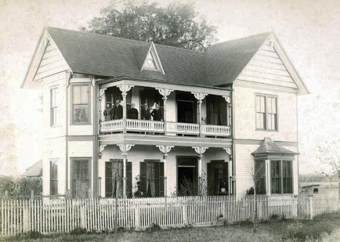 This 1890s photo graph pictures Augusta (Willenberg) and William Hermes,Jr., Louise (Holste) and Dr. William Hermes, and August Hermes on the upper balcony of William Hermes Jr.’s home, at 541 North Main St., La Grange.