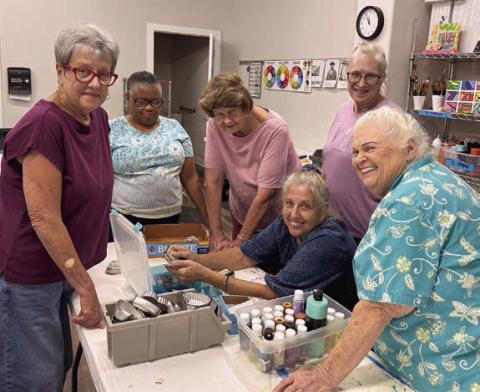 A group of art students surround Diana Chafin (seated) during her assemblage class, a big hit on Artful Fridays. The students enjoy digging through the masses of cast of items and scraps to make “found-object” sculptures. Viewing Chafin’s secret stash of special buttons are (standing, from left) Sheryl Tumis, Janice Collins, Delores Bittner, Cindy Ferguson and Glenda Genzer. The classes are made possible through Senior Connections’ partnership with Arts for Rural Texas.