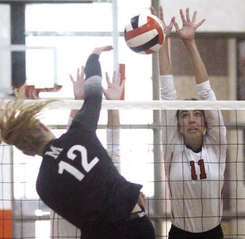 Meredith Magliolo goes up to block a Crusader attack in game two. Sticker Photo By Darrell Vyvjala