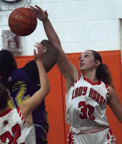 Grace Schramek blocks a shot in the first half against Weimar. Sticker Photo By Darrell Vyvjala