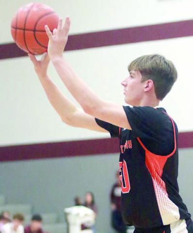 William Eudy releases one of his two three-point field goals in the third quarter against Flatonia. Sticker Photo By Darrell Vyvjala