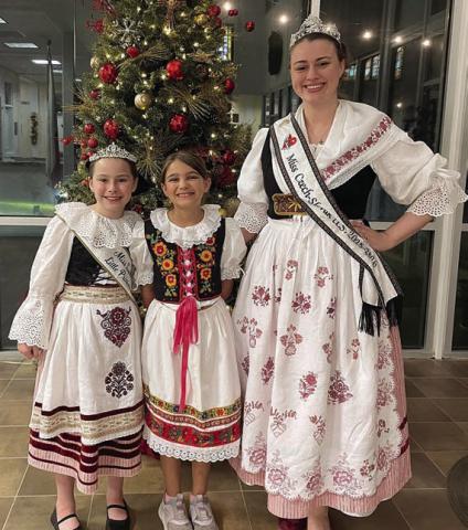 Wearing Czech krojs at the Fayette County Czech Heritage Society Christmas party were (from left) 2025-26 Miss Texas-Czech Slovak Little Princess Lillie Karstedt, Maelynn Wasut, and 2025-26 Miss U.S. Czech-Slovak Queen Madelyn Karstedt