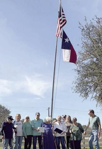 The home of Carol Lighthill in Columbus was selected to receive the February award for flag display by the Daughters of the American Revolution, John Everett Chapter, and the Sons of the American Revolution, Robert Rankin Chapter. Shown are the DAR/SAR representatives and the honoree – (front row, from left) Rick and Stephanie Mattix, Wanda Anglin, David Zachmeyer, Carol Lighthill, Judy Zachmeyer, Donna Pustejovsky, Nelma and Glen Strey, and (back) Debra and Brian Thye.