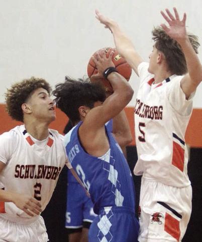 Denver Carr (left) and Jamison Bennett (right) harass a Wildcat in the Horns’ win last Tuesday. Sticker Photo By Darrell Vyvjala