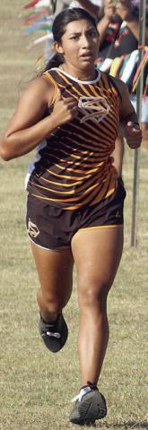 Ruby Rodriguez sprints down the hill to the finish line ahead of the rest of the field to win the 28-2A individual title. Sticker Photo By Darrell Vyvjala