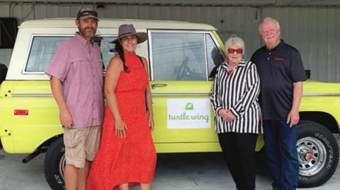 Betty and John Burkland (right) donated a 1972 Ford Bronco which was raffled to benefit Turtle Wing Foundation. The winner was Julie Shumney (second from left) and also shown is Andy Slater (left).