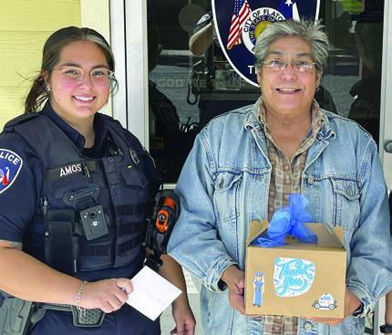 A box of freshl y baked goods was presented to Flatonia Police Officer Taylor Amos (left) by Senior Connections director Cindy Villarreal (right). The baking group also made boxes for Flatonia City Hall and Flatonia Fire &amp; Rescue.