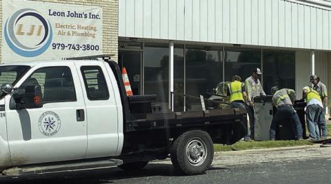 As part of the move from 535 North Main St. to the temporary City Hall location at 605 Upton Ave. (Leon John’s, Inc.), City workers unload a copy machine on Friday. Sticker Photo By Darrell Vyvjala