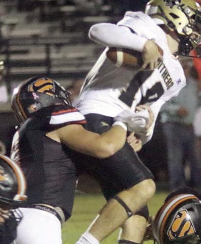 Owen Brenek makes a third-down tackle in the first quarter. Sticker Photo By Layne Vyvjala