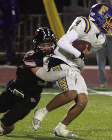 Emerson Harvey sacks Ayden Ramirez for a loss of 10 in the first quarter. Sticker Photo By Darrell Vyvjala