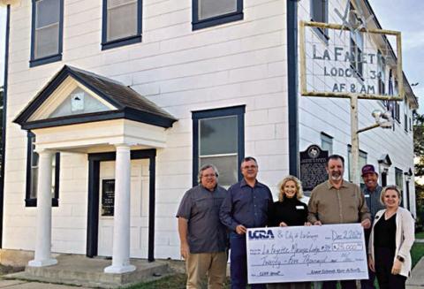 A $25,000 grant was presented by LCRA representatives to La Fayette Masonic Lodge 34 for improvements to its historic building as part of LCRA’s Community Development Partnership Program. Shown are (from left) Jeffrey L. Messer, lodge junior warden; Scott Noles, lodge worshipful master; Margaret D. “Meg” Voelter, LCRA board member; Jerry Meek, lodge secretary; Matthew L. “Matt” Arthur, LCRA board member; and Kate Ramzinski, LCRA regional affairs representative.
