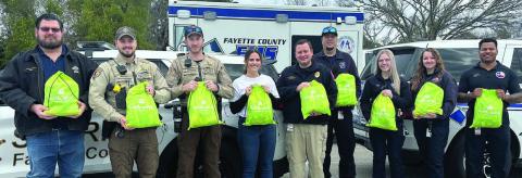 A new initiative for Turtle Wing Foundation is providing sensory bags to Fayette County first responders. Shown with the sensory bags are (from left) Investigator Jeremy Castleberry, Deputy Jared Michalec and Deputy Wesly Arrison of the Fayette County Sheriff’s Department; Turtle Wing executive director Destiny Siptak; EMS director Josh Vandever; and captain Jarrett Bise, EMT Kaitlyn Witt, paramedic Taylor Spackman and assistant director Gary Daniels of the Fayette County EMS.