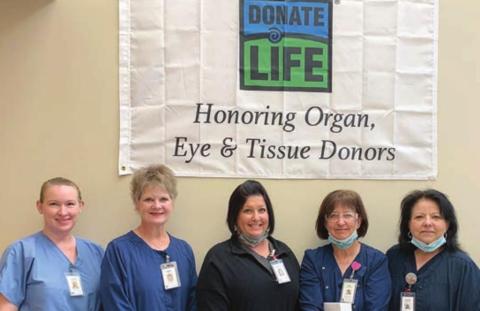 A “DONATE LIFE” banner honoring organ, eye and tissue donors hangs at St. Mark’s Medical Center. Standing in front of it are team members (from left) Jenifer Leyendecker, director of surgical and ambulatory care services; Tammy Hartfield, chief clinical officer; Amanda Fuchs, director of laboratory services; Kim Lookingbill, emergency services director; and Laurie Quitta, MedSurg director.
