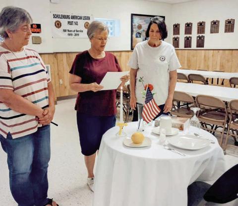 The table and its contents hold special significance for the solemn POW/MIA ceremony. The table, set for one, includes a white tablecloth, red rose, yellow ribbon, slice of lemon, salt, inverted glass, empty chair and candle. Legion Auxiliary members conducting the ceremony included (from left) Debbie Behlen, Patricia Hranicky and Patricia Marty.