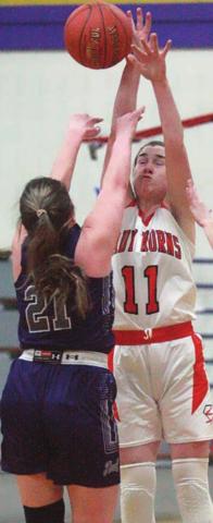 Morgan Marburger defects a Thrall pass in the second half. Sticker Photo By Darrell Vyvjala