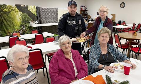 Schulenburg Police Department Officer Chris Kalina (back left) receives a platter of cookies from some of the members at Senior Connections. Present that day were (front row, from left) Clara Christ, Cynthia Meyer, Judy Klesel, and (back right) Aileen Kasper.