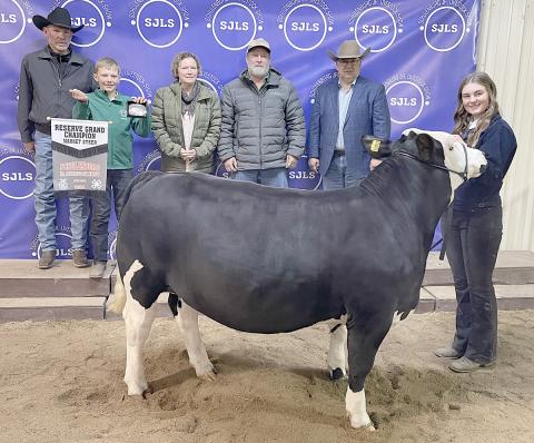 RESERVE CHAMPION MARKET STEER – Exhibitor: Madyson Holub (right). Weight: 1,235 pounds. Sales price: $9,000. Sticker Photo By Darrell Vyvjala