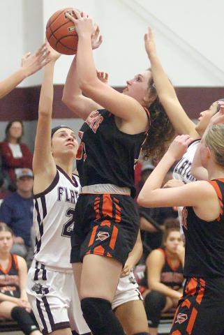 Grace Schramek pulls down one of her four offensive rebounds and nine total  against Flatonia. Sticker Photo By Darrell Vyvjala