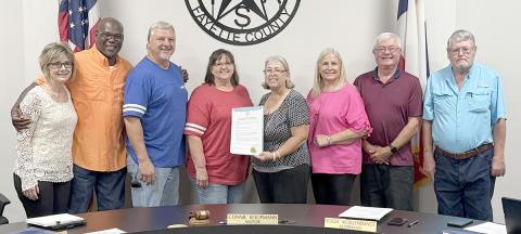 At the Schulenburg City Council meeting on Nov. 4, a proclamation honoring Audio Video Plus was presented. Shown are (from left) City Administration Tami Walker, Alderman Greg Thomas, Bruce and Joann Lebeda of Audio Video Plus, Mayor Connie Koopmann, Alderman Kathy Kleiber, Alderman  Roger Moellenberndt and Alderman Clarence Ahlschlager. Sticker Photo By Layne Vyvjala