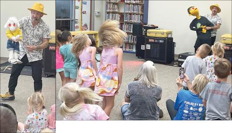 Puppeteer Mr. Leo and his cool goat (left) interact with youngsters after the children enjoyed a song and dance with him and his buddy, “Tommy” (above). The show last Friday morning was the first of the local public library’s Summer Reading Program that continues through late July. Sticker Photos By Darrell Vyvjala