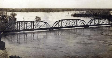 Photograph of the MKT railroad bridge across the Colorado River at La Grange on the evening of Dec. 5, 1913. Courtesy of Fayette Heritage Museum &amp; Archives