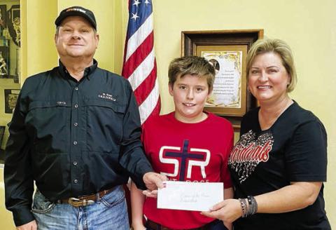 Roland Vacek (left) was the St. Rose winner in the Catholic Life Insurance sweepstakes. He purchased his ticket from his nephew, Nathan Vacek (center). Also shown is Jeannie Mican (right), St. Rose School administrative assistant.