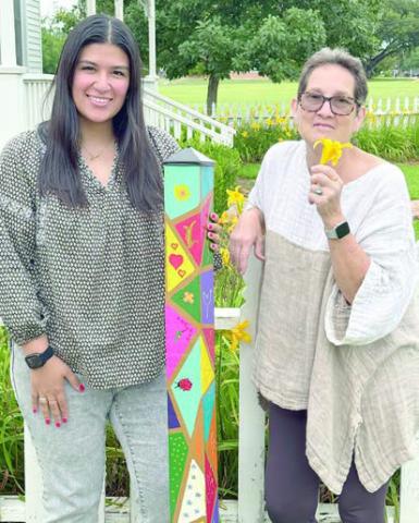 A garden pole was presented to Stanzel Family Foundation, represented by Melanie Ramirez (left), as a gift for its support of Senior Connections, represented by program director Stephanie Shroyer (right).