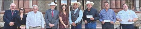 Checks presented – (from left) John Wied, attorney for Steve Hillhouse; Summer Hillhouse and Steve Hillhouse; County Judge Dan Mueller; Court Administrator Cassie Austin; Precinct 2 Commissioner Luke Sternadel; Sheriff Keith Korenek, representing the Fayette County Sheriff's Department; Chief Frank Menefee, representing the La Grange Volunteer Fire Department; and Director Josh Vandever, representing the Fayette County EMS.