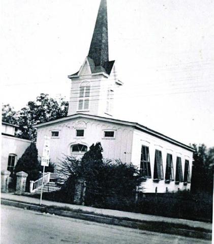 Union Church with the shutters of five large widows on the west side tilted open for air circulation. There are also three small windows across the upper front. Photo Courtesy of First Presbyterian Church