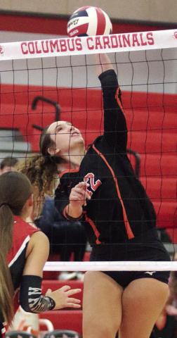 Grace Schramek connects on a spike for a point in the first match against West in the Columbus tourney. Sticker Photo By Darrell Vyvjala