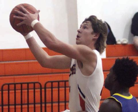 Aaron Janecek heads to the basket for a layup in the second quarter of the Horns’ 40-point win over Louise. Sticker Photo By Darrell Vyvjala