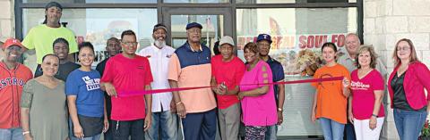 Real Deal Soul Food cuts ribbon