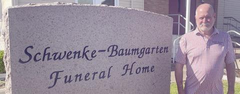 Mark Klesel poses outside the funeral home last Thursday. Sticker Photo By Darrell Vyvjala