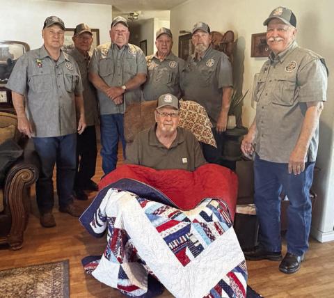 John Dodson (front), Vietnam veteran who served in the U.S. Army, was recently presented a Quilt of Valor by Vietnam Veterans of America Chapter 870. Dodson was not only a founding member and original officer of VVA Chapter 870 but is also a retired teacher in Schulenburg. Delivering the quilt to Dodson were VVA 870 members (back row, from left) Don Christen, Eugene Krupala, Daniel Kutac, Frank White, Gerald Smith and Andy Janda.