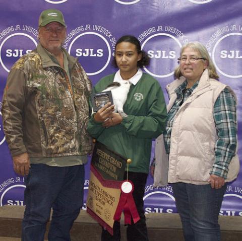 RESERVE CHAMPION MARKET RABBITS – Exhibitor: Elizabeth Shank (center). Sales price: $4230. Sticker Photo By Darrell Vyvjala