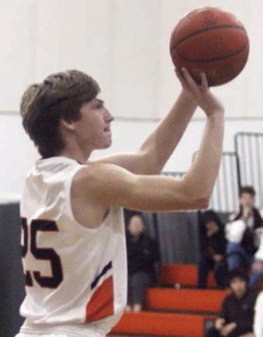 Zane Brenek releases the three-pointer that put the Horns up 50-46 in the fourth quarter Friday. Sticker Photo By Darrell Vyvjala