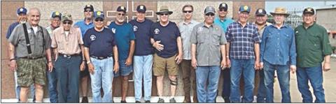 MEMBERS OF American Legion Post 143, Sons of the American Legion, Legion Riders and Vietnam Veterans Chapter 870 gathered on Monday, May 20 to place flags on the graves of deceased veterans. A group of these veterans is shown in front of the mausoleum at the St. Rose of Lima Catholic Cemetery.
