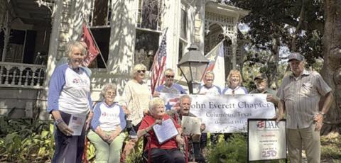Bob and Nancy Stiles (front, holding certificates) feel that flying the American flag shows pride in this country. They also fly the Texas flag and the Columbus Cardinals flag. DAR/SAR representatives shown are (back row, from left) Judy Zachmeyer, Glen Strey (behind Zachmeyer), Nelma Strey, Connie Dittrich, Marti Herring, Donna Pustejovsky, Stephanie and Rick Mattix, and Dave Zachmeyer.
