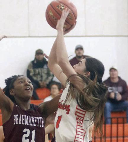 Ava Faith scores in the lane to help the Lady Horns build a 25-14 halftime lead over East Bernard. Sticker Photo By Darrell Vyvjala